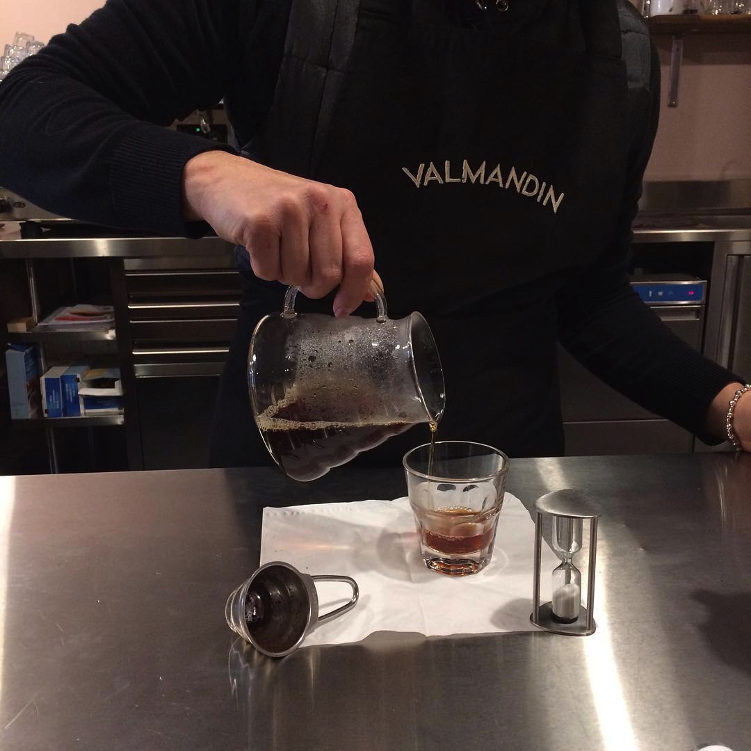 A cup of freshly brewed Valmandin filter coffee poured from a Hario brewer.