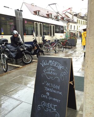 The Valmandin signage out on a rainy street. The perfect moment for a warm cup of freshly roasted and brewed Valmandin gourmet coffee.