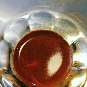 Very dense Valmandin espresso crema in a glass cup seen from above.